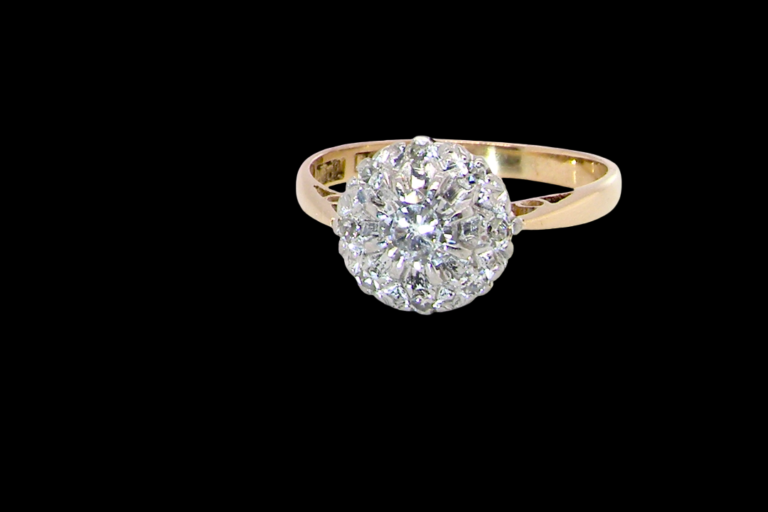 A vintage mid 20th century cluster ring. Principle stone a brilliant cut white diamond, 4mm