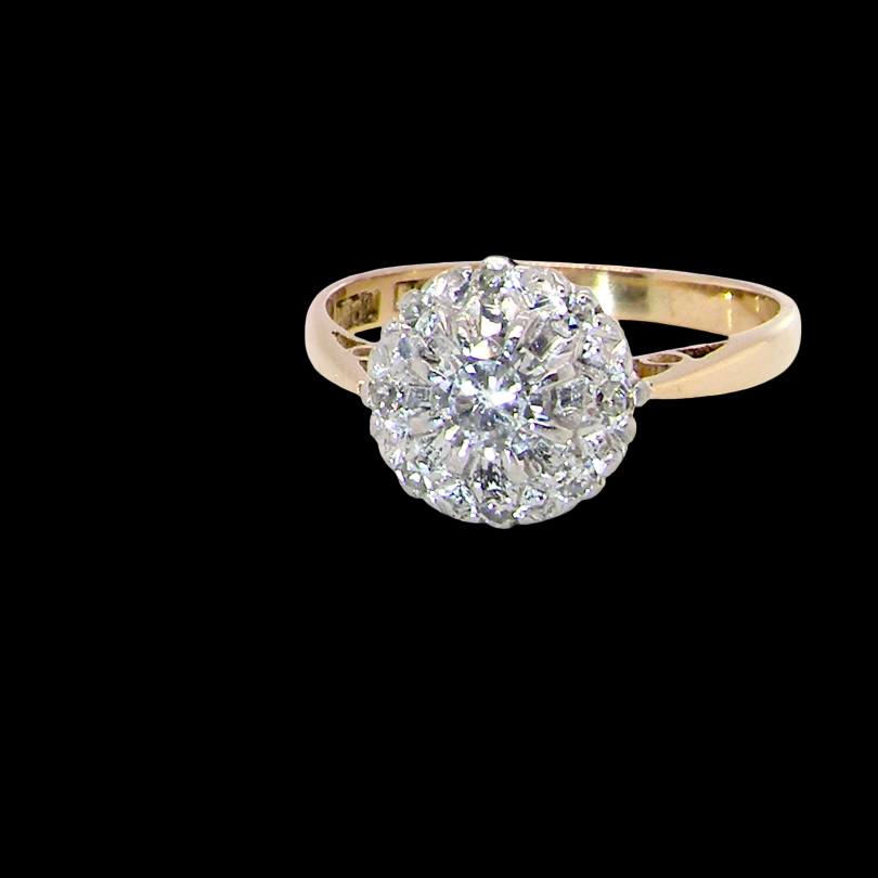 A vintage mid 20th century cluster ring. Principle stone a brilliant cut white diamond, 4mm