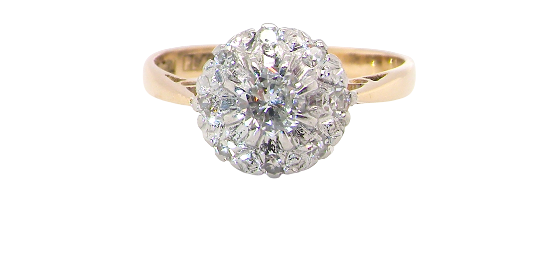 A vintage mid 20th century cluster ring. Principle stone a brilliant cut white diamond, 4mm (0.25 carats est)