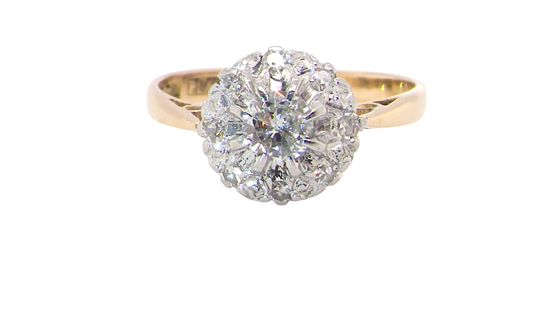 A vintage mid 20th century cluster ring. Principle stone a brilliant cut white diamond, 4mm (0.25 carats est)