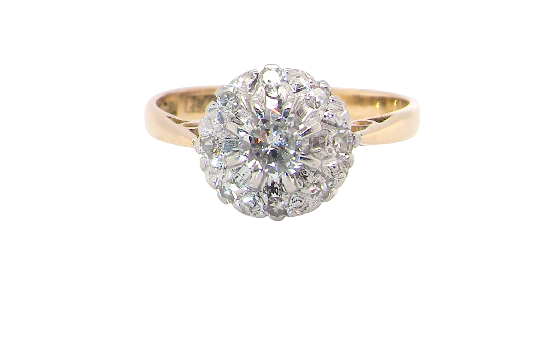 A vintage mid 20th century cluster ring. Principle stone a brilliant cut white diamond, 4mm (0.25 carats est)