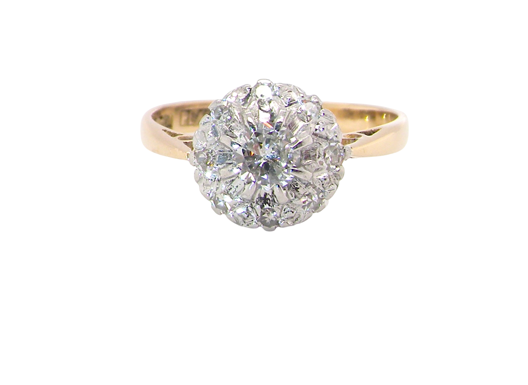 A vintage mid 20th century cluster ring. Principle stone a brilliant cut white diamond, 4mm (0.25 carats est)