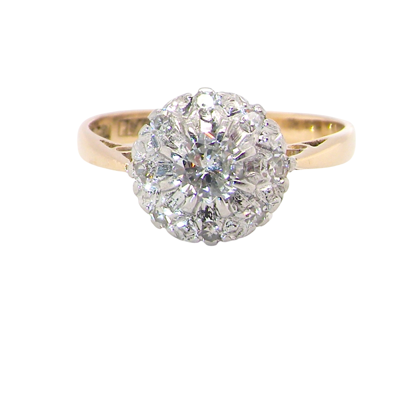 A vintage mid 20th century cluster ring. Principle stone a brilliant cut white diamond, 4mm (0.25 carats est)