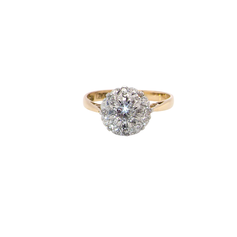 A vintage mid 20th century cluster ring. Principle stone a brilliant cut white diamond, 4mm (0.25 carats est) clarity i-j, clarity Si.