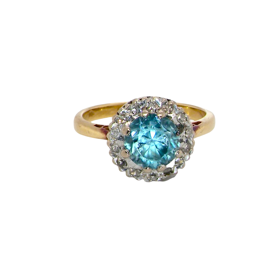 A vintage mid 20th century cluster ring.
Centre stone a blue zircon, 7mm diameter.
