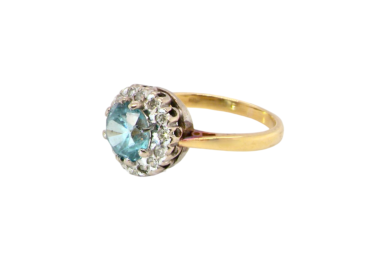 A vintage mid 20th century cluster ring.
Centre stone a natural blue zircon,