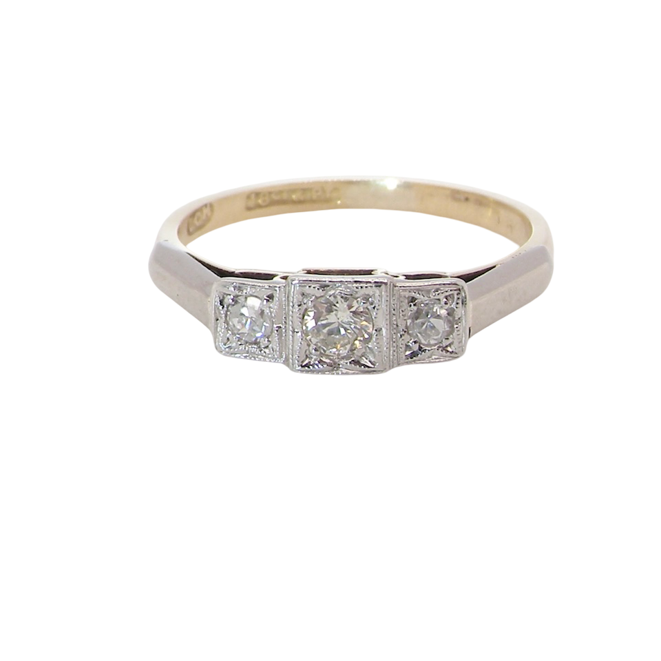 A trilogy ring. Set with three old brilliant cut white diamonds, centre 3mm and each side a 2.4mm diamond. Total estimated at 0.20 carats, colour H-j, clarity Si