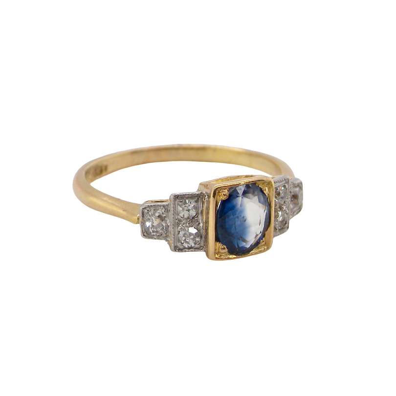 A vintage ring that features to the centre a substantial sapphire and to each side set in platinum three small diamonds. side