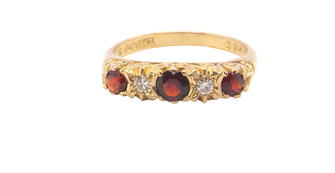 A vintage style 18 carat gold boat shaped ring. Features three dark red garnets, centre 4mm, each end a 3mm stone. 