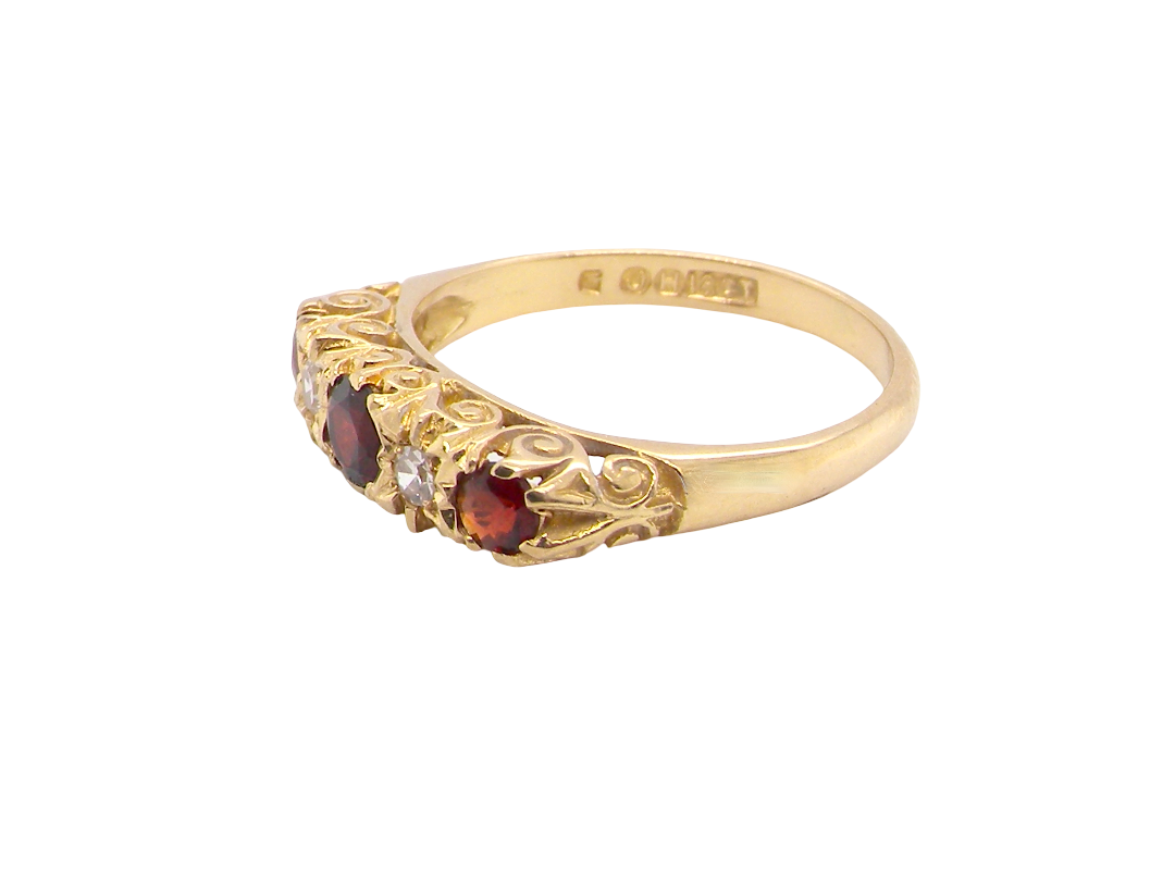 A vintage style 18 carat gold boat shaped ring. Features three dark red garnets, centre 4mm, each end a 3mm stone.
side