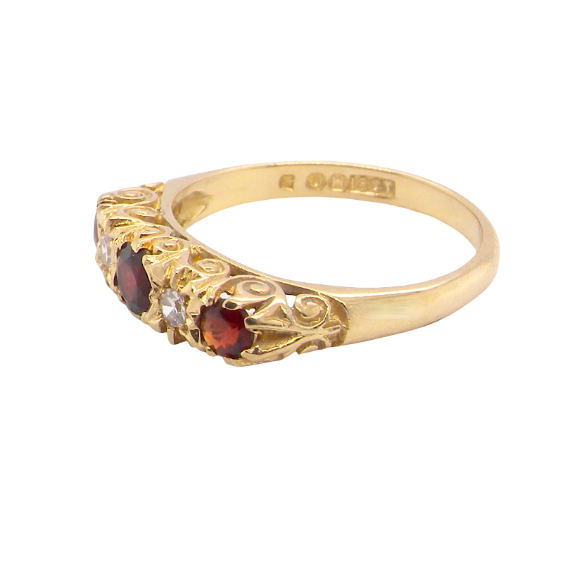A vintage style 18 carat gold boat shaped ring. Features three dark red garnets, centre 4mm, each end a 3mm stone.
side