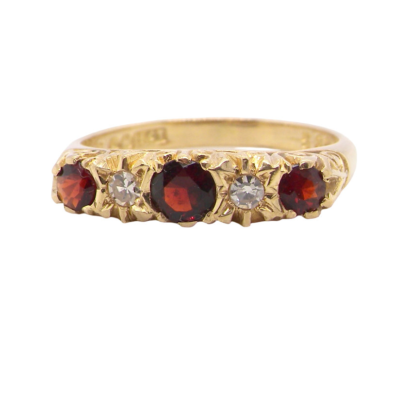 A vintage style 18 carat gold boat shaped ring. Features three dark red garnets, centre 4mm, each end a 3mm stone