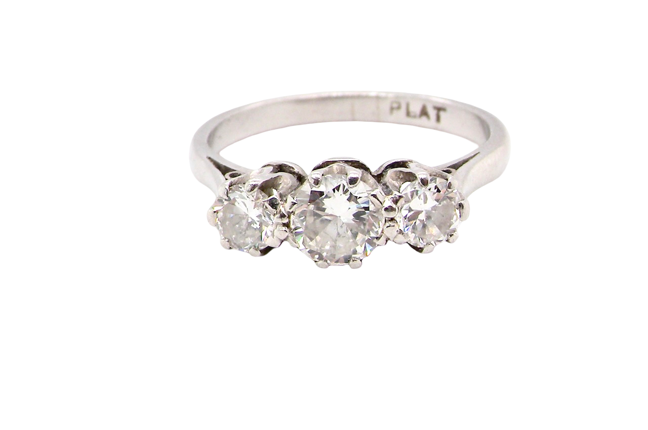 Diamond ring with three stones on a white background