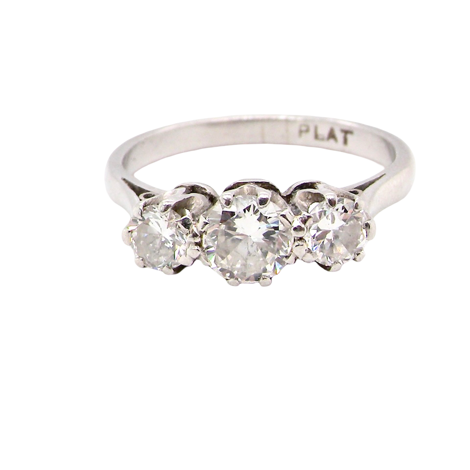 Diamond ring with three stones on a white background