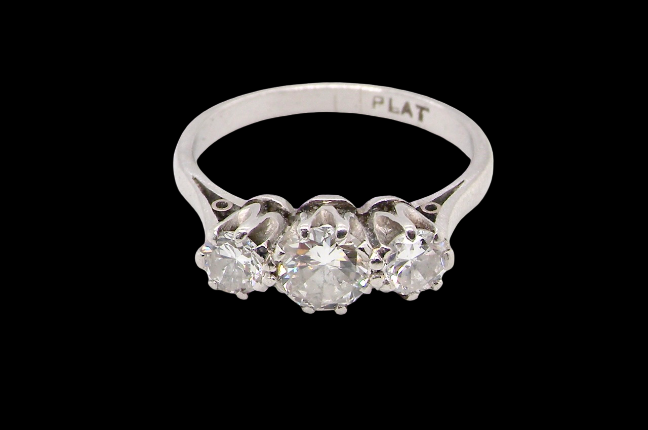 Diamond ring with 'PLAT' marking on a black background