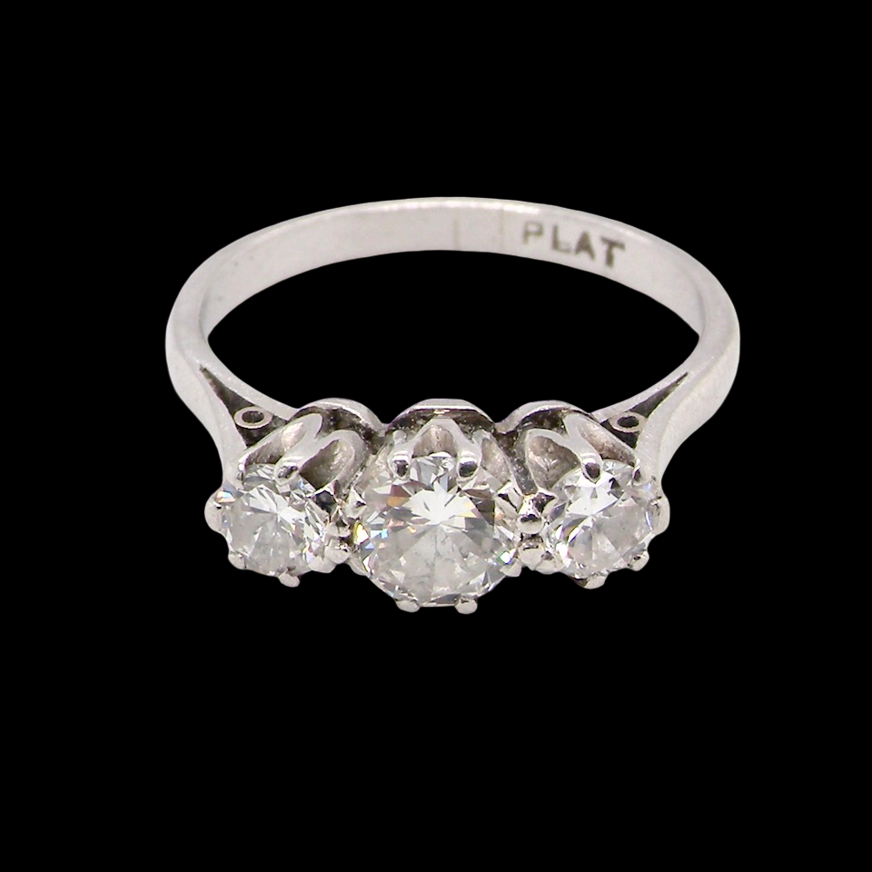 Diamond ring with 'PLAT' marking on a black background
