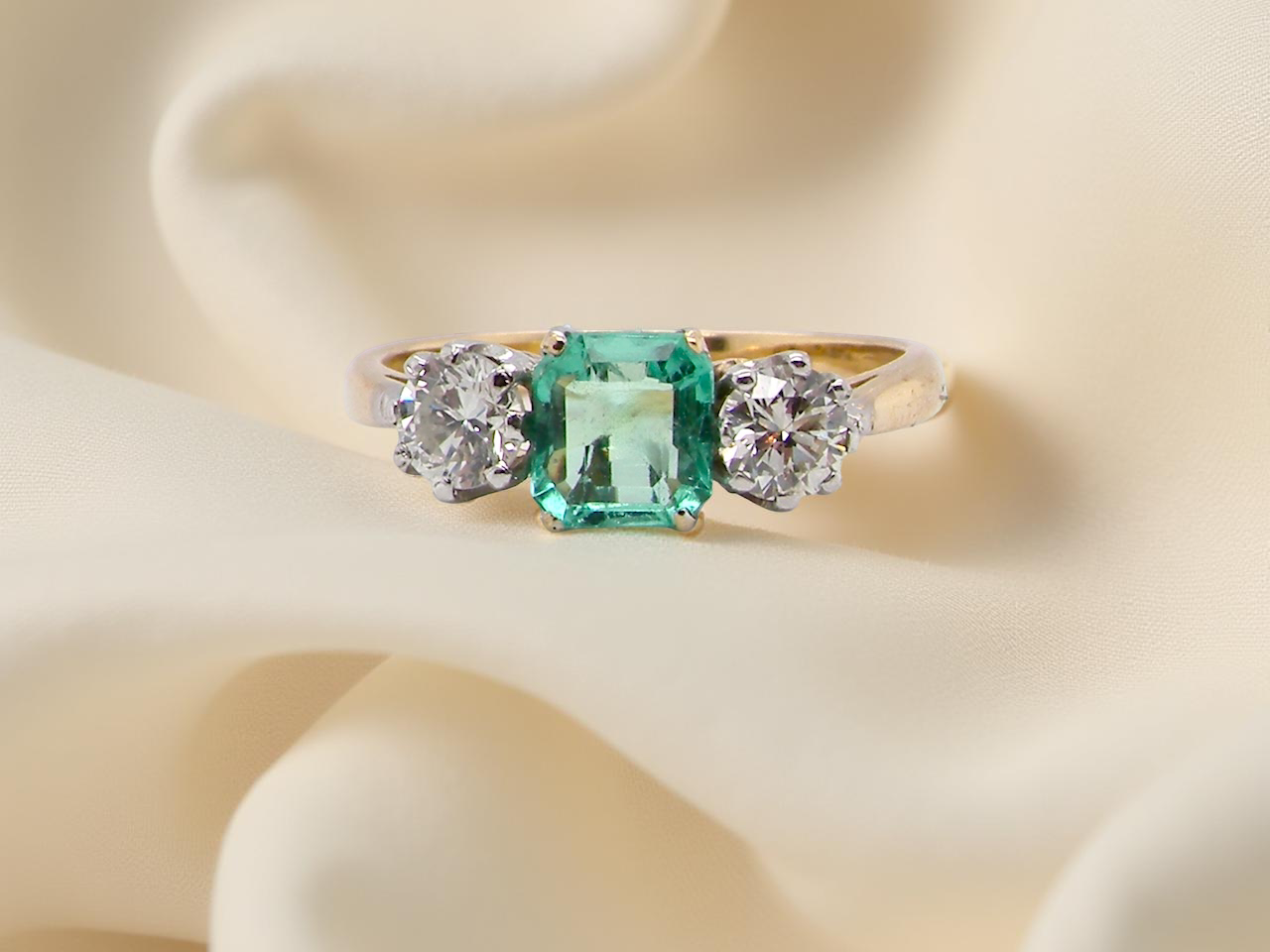 A vintage three stone Emerald and Diamond ring