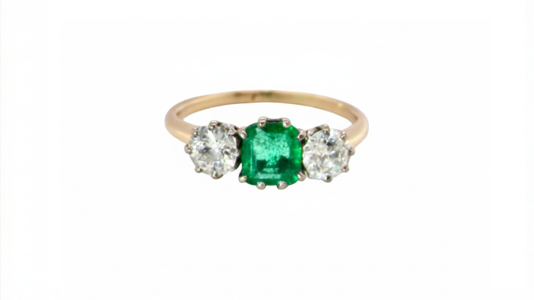 An emerald and diamond trilogy ring