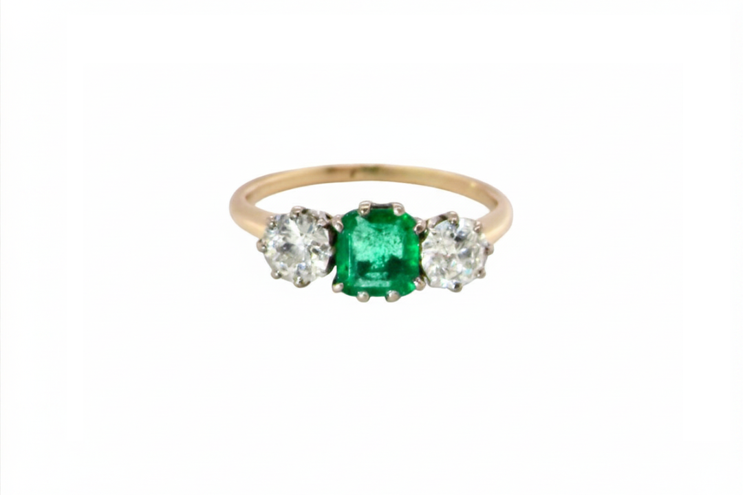 An emerald and diamond trilogy ring