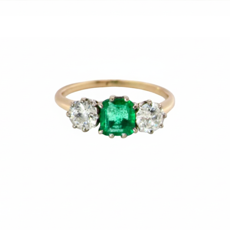 An emerald and diamond trilogy ring