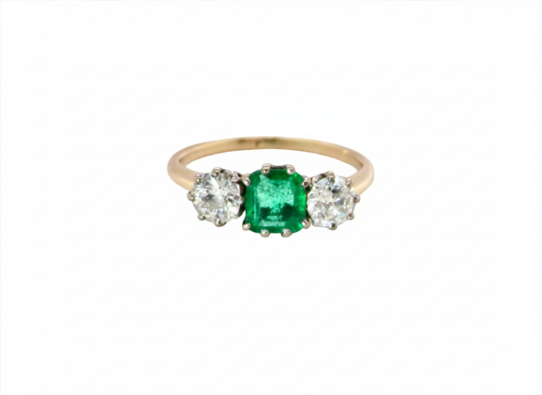 An emerald and diamond trilogy ring