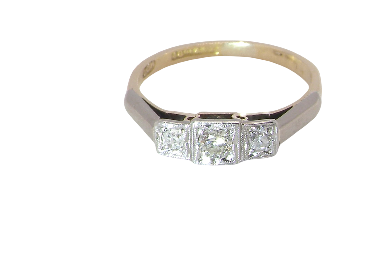 A vintage trilogy ring. Set with three old brilliant cut white diamonds, centre 3mm and each side a 2.4mm diamond. Total estimated at 0.20 carats, colour H-j, clarity Si