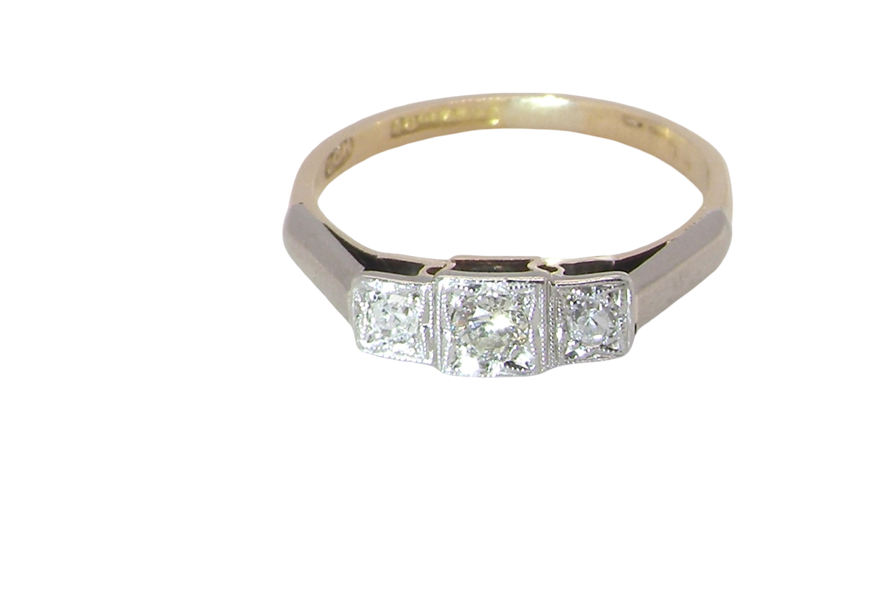 A vintage trilogy ring. Set with three old brilliant cut white diamonds, centre 3mm and each side a 2.4mm diamond. Total estimated at 0.20 carats, colour H-j, clarity Si