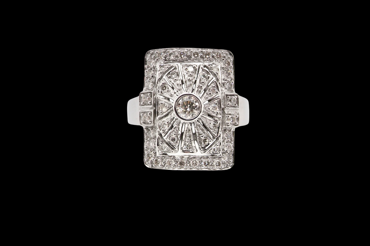 Diamond ring with a central gemstone and diamond-studded band on a black background