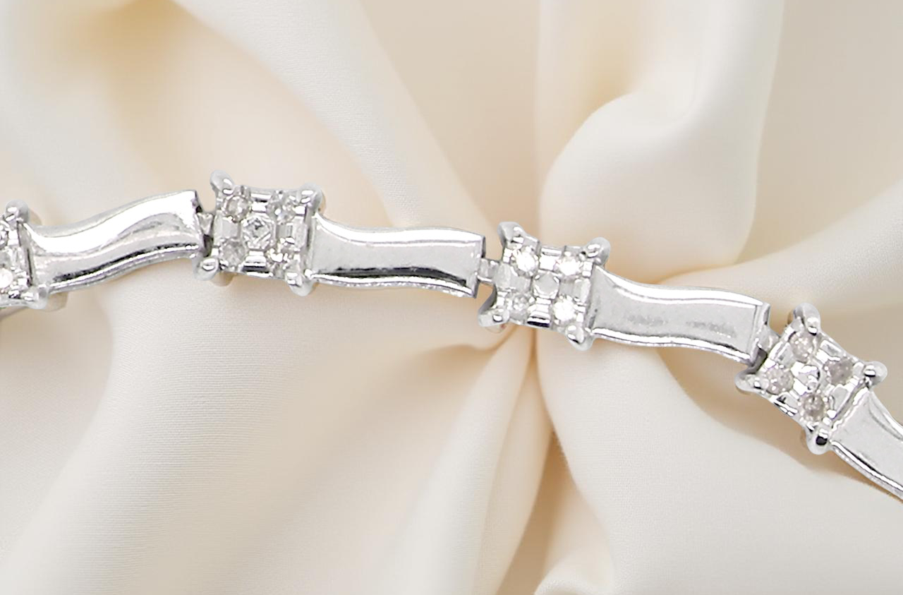 bracelet with diamond accents on a soft beige background