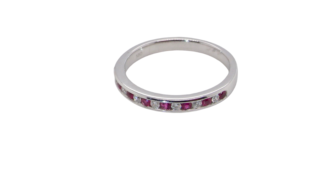 A white gold half hoop eternity ring. Set with seven round rubies and six brilliant cut white diamonds new