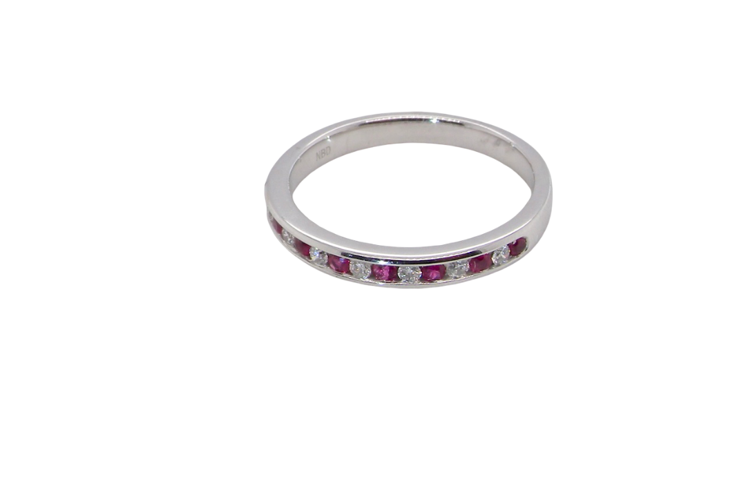 A white gold half hoop eternity ring. Set with seven round rubies and six brilliant cut white diamonds new