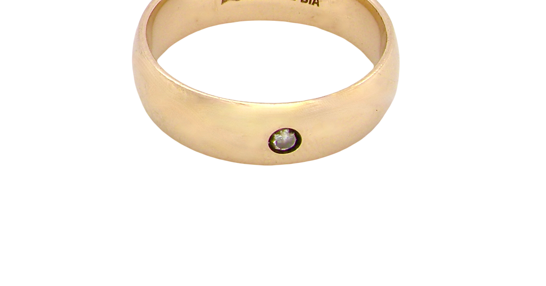 A wide 9 carat gold wedding ring. Set with a diamond