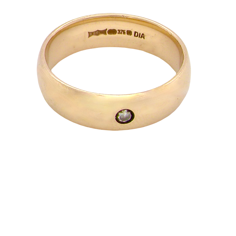 A wide 9 carat gold wedding ring. Set with a diamond