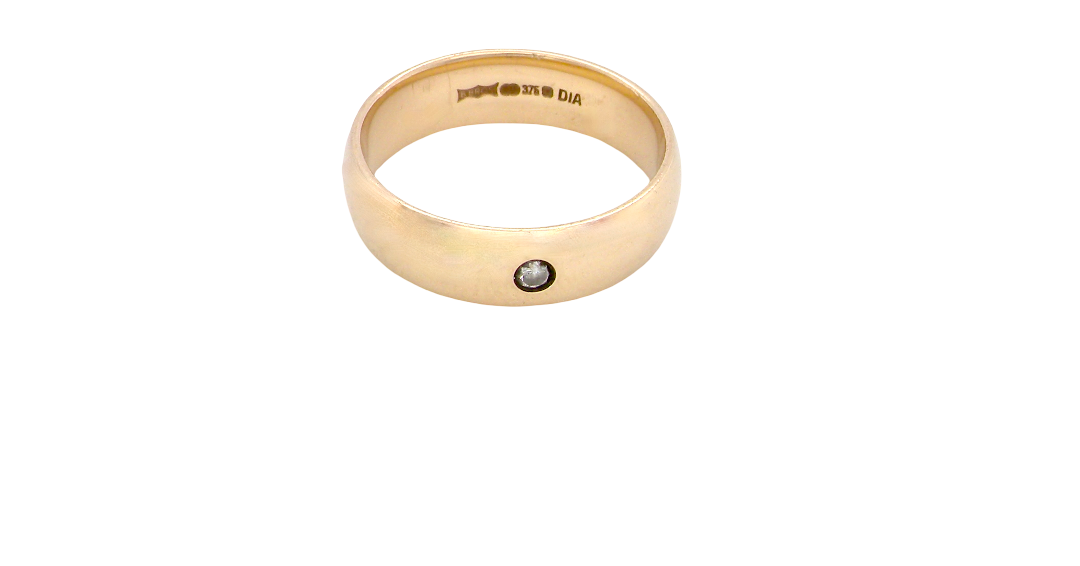 A wide 9 carat gold wedding ring. Set with a small diamond