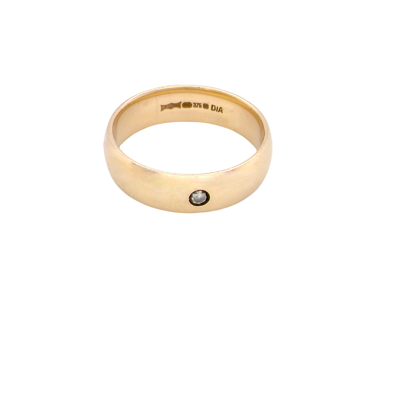 A wide 9 carat gold wedding ring. Set with a small diamond
