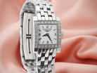 Silver Longines watch on a soft pink background