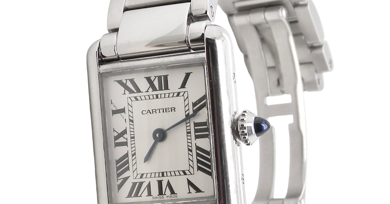 A womans stainless steel Cartier Tank Must wrist watch. Model number WSTA0051.
Silver coloured dial with Roman Numerals. Blue steeled hands. Case measures 29.5x22mm, case thickness 6.6mm. Quartz
