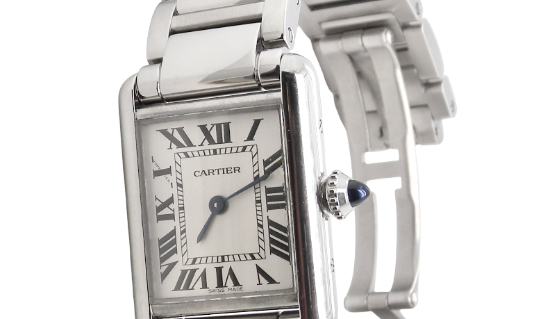 A womans stainless steel Cartier Tank Must wrist watch. Model number WSTA0051.
Silver coloured dial with Roman Numerals. Blue steeled hands. Case measures 29.5x22mm, case thickness 6.6mm. Quartz