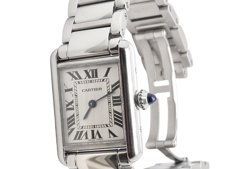 A womans stainless steel Cartier Tank Must wrist watch. Model number WSTA0051.
Silver coloured dial with Roman Numerals. Blue steeled hands. Case measures 29.5x22mm, case thickness 6.6mm. Quartz