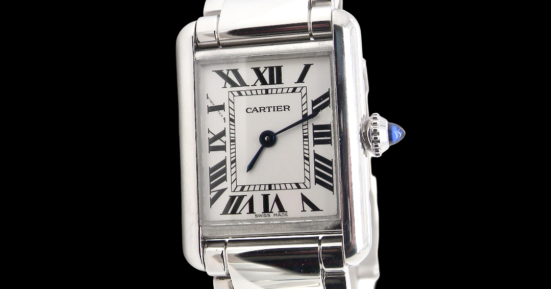A womans stainless steel Cartier Tank Must wrist watch. Model number WSTA0051.
Silver coloured dial with Roman Numerals. Blue steeled hands. Case measures 29.5x22mm, case thickness 6.6mm. Quartz movement,