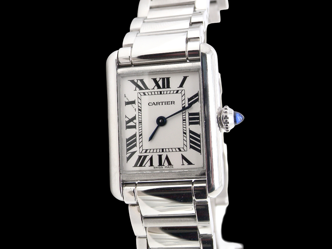 A womans stainless steel Cartier Tank Must wrist watch. Model number WSTA0051.
Silver coloured dial with Roman Numerals. Blue steeled hands. Case measures 29.5x22mm, case thickness 6.6mm. Quartz movement,