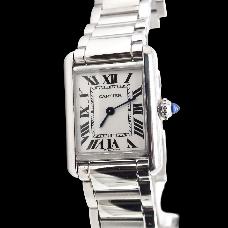 A womans stainless steel Cartier Tank Must wrist watch. Model number WSTA0051.
Silver coloured dial with Roman Numerals. Blue steeled hands. Case measures 29.5x22mm, case thickness 6.6mm. Quartz movement,