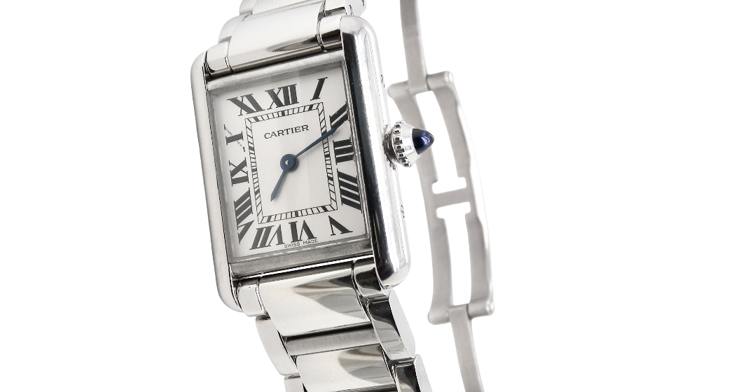 A womans stainless steel Cartier Tank Must wrist watch. Model number WSTA0051.
Silver coloured dial with Roman Numerals. Blue steeled hands. Case measures 29.5x22mm, case thickness 6.6mm. Quartz movement, synthetic sapphire button.