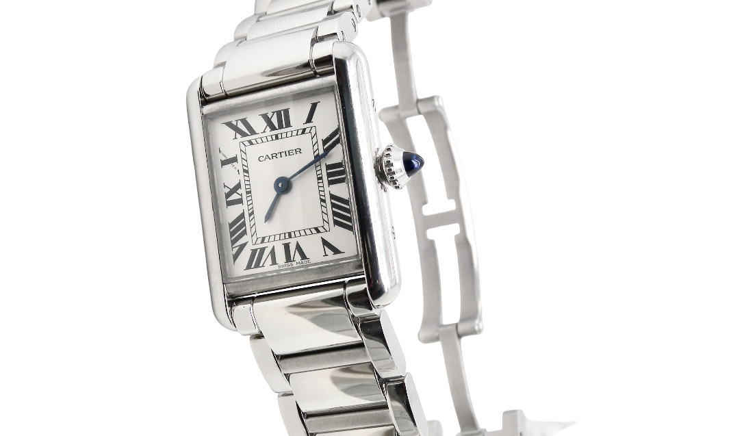 A womans stainless steel Cartier Tank Must wrist watch. Model number WSTA0051.
Silver coloured dial with Roman Numerals. Blue steeled hands. Case measures 29.5x22mm, case thickness 6.6mm. Quartz movement, synthetic sapphire button.