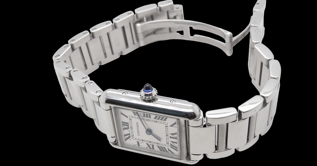 A womans stainless steel Cartier Tank Must wrist watch. Model number WSTA0051.
Silver coloured dial with Roman Numerals. Blue steeled hands. Case measures 29.5x22mm, case thickness 6.6mm. Quartz movement, synthetic sapphire button.
side