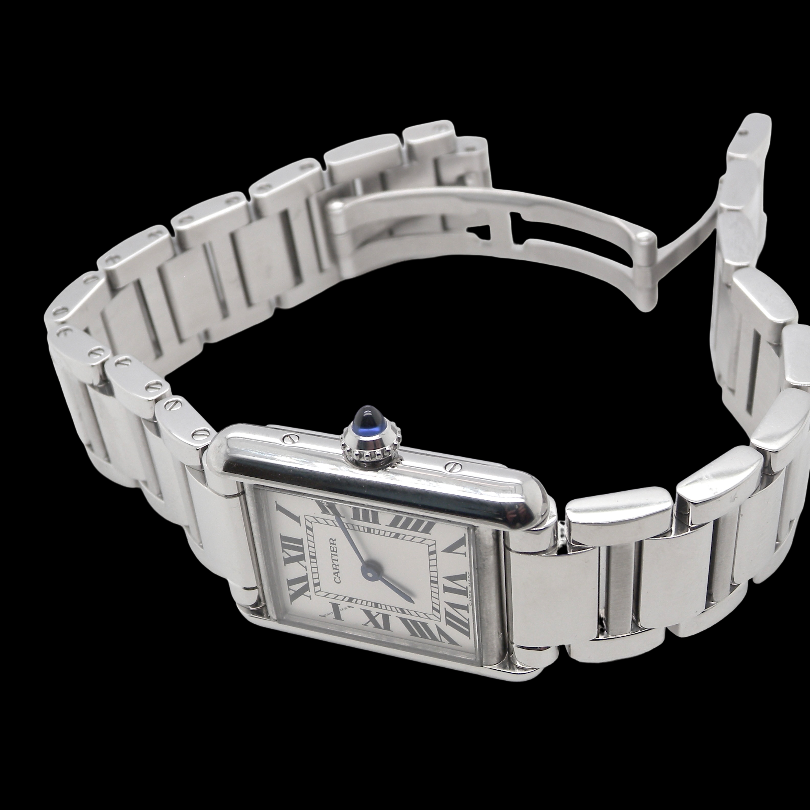 A womans stainless steel Cartier Tank Must wrist watch. Model number WSTA0051.
Silver coloured dial with Roman Numerals. Blue steeled hands. Case measures 29.5x22mm, case thickness 6.6mm. Quartz movement, synthetic sapphire button.
side
