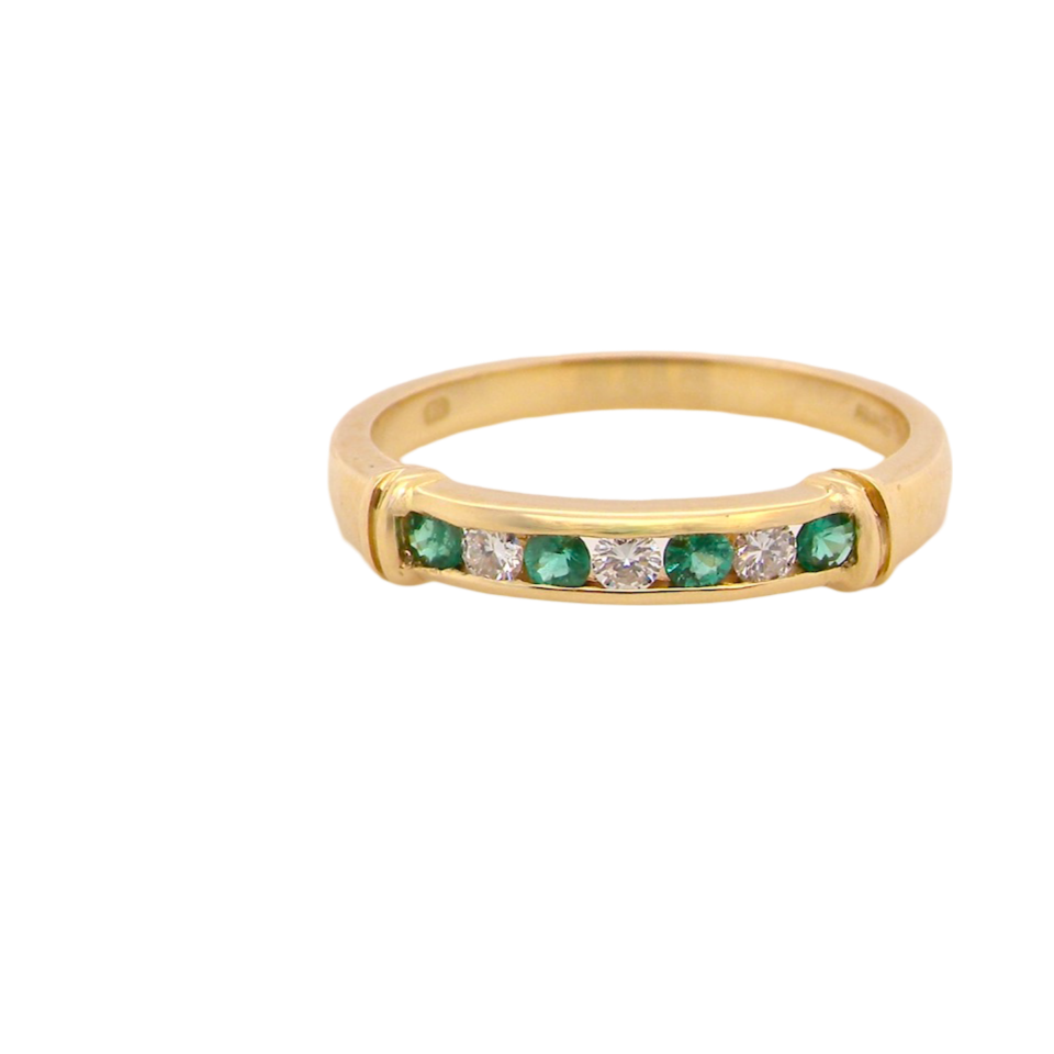 An 18 carat gold Emerald and Diamond Eternity ring