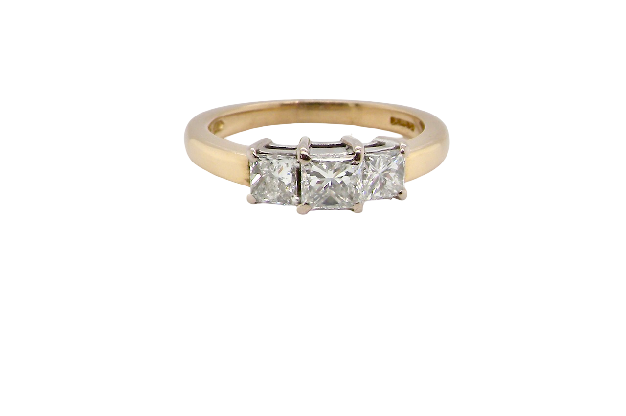 Gold ring with three diamonds on a white background