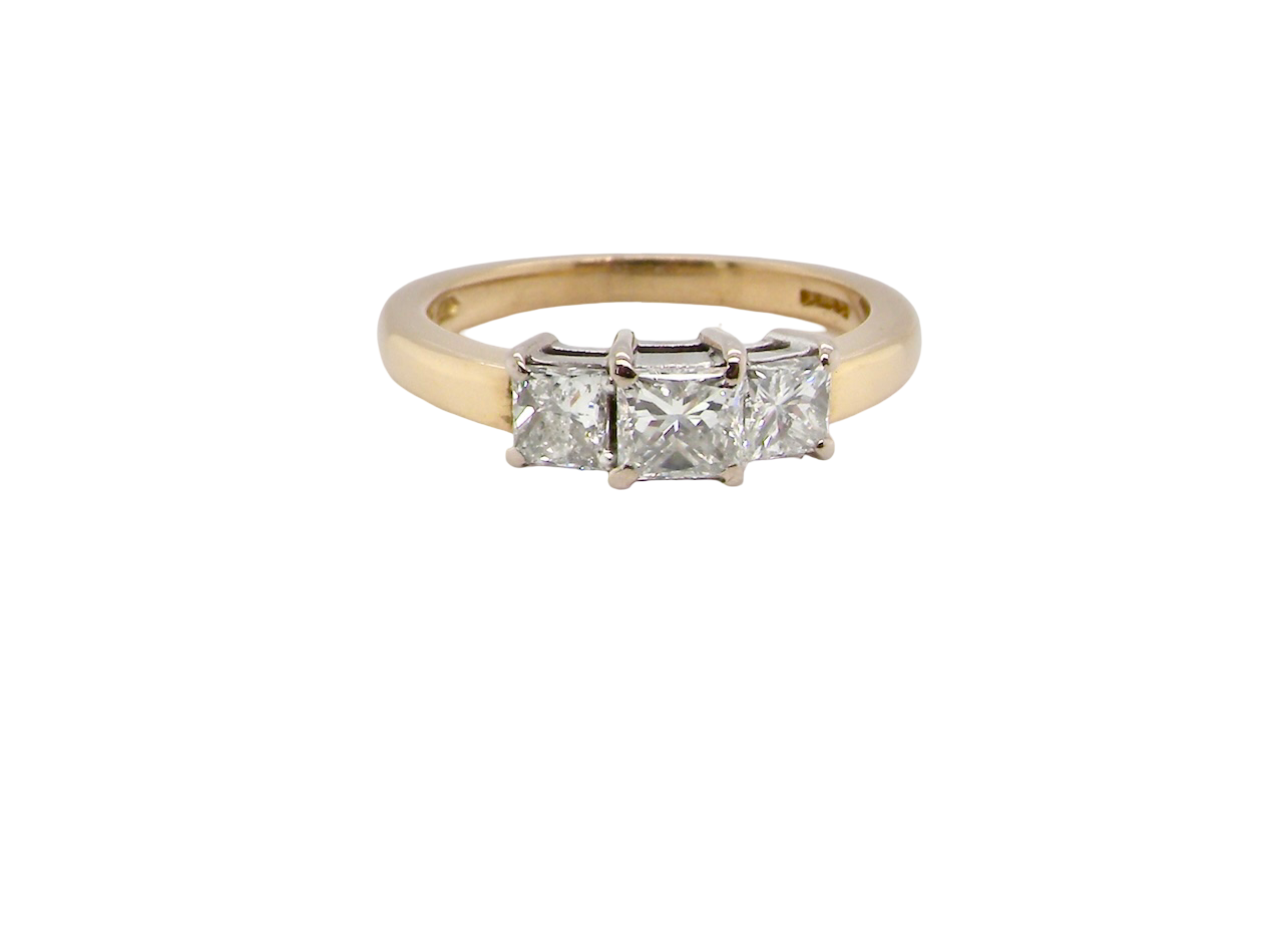 Gold ring with three diamonds on a white background