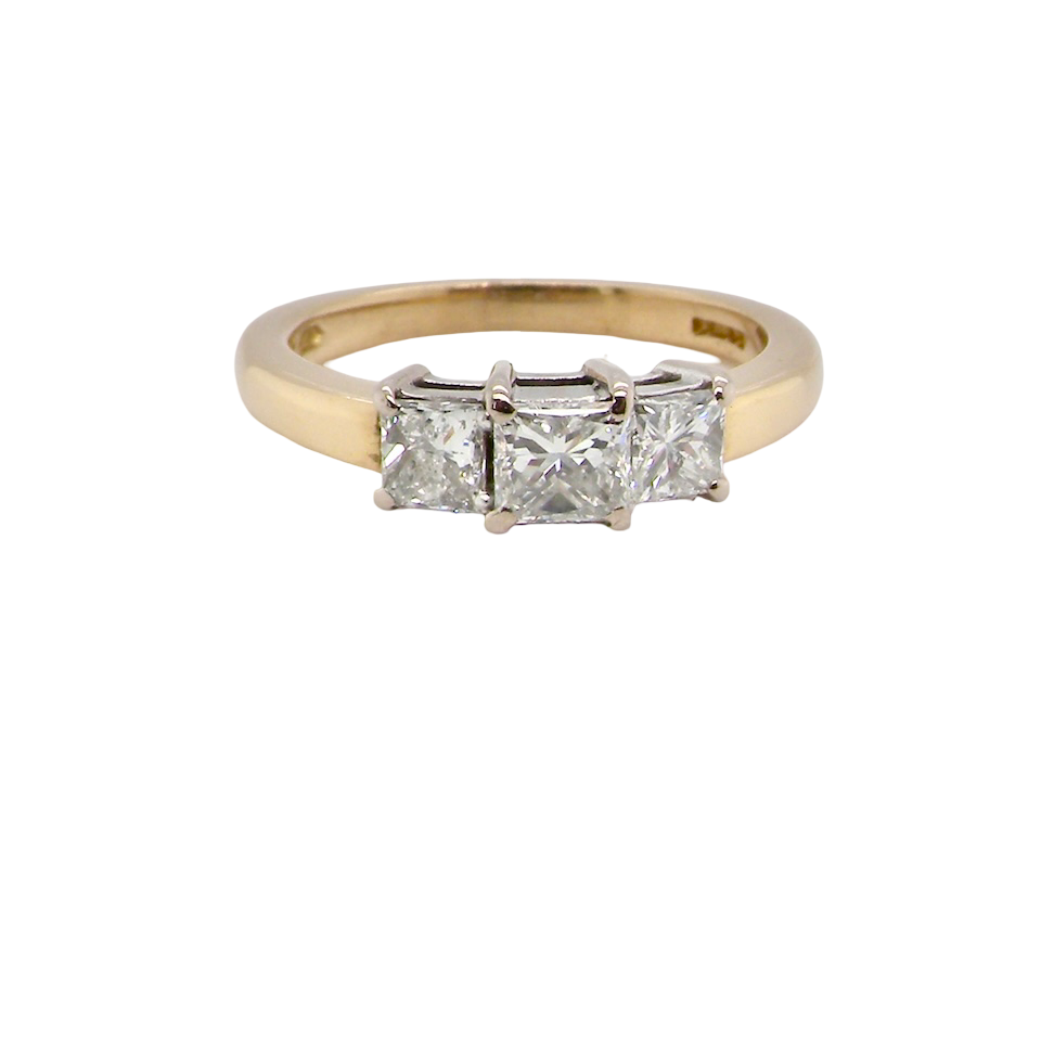 Gold ring with three diamonds on a white background